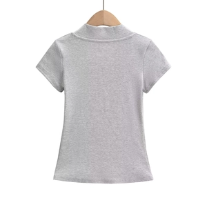 Detail view of the grey rib-knit mock neck tee back showing texture and fit on a hanger