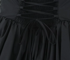 Detailed macro view of the back lace-up design with elegant black crisscross ribbons