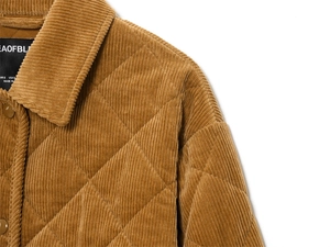 Close-up of diamond quilted texture and lapel collar on a brown corduroy jacket