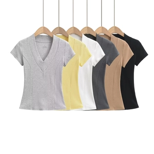 Detail of V-neck short sleeve T-shirts in six colors hanging on wooden hangers