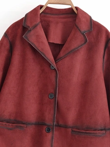 Detail of red suede jacket with vintage distressed finish and contrast buttons