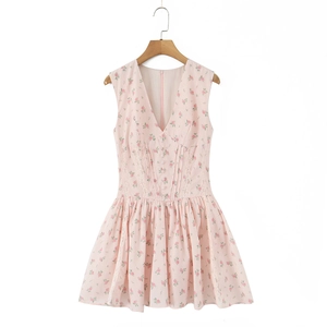Detail view of pink floral dress featuring deep V-neck with delicate lace trim and buttons