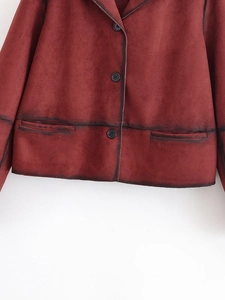 Detail of dark red faux suede jacket with vintage distressed edges and dark buttons