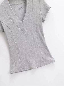 Detail of grey ribbed cotton V-neck tee showing S-size label and fabric composition