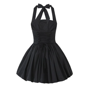 Detail of black halter neck dress featuring bow tie and corset lace-up back design