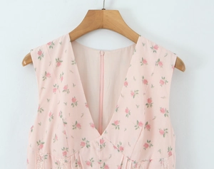 Detail of pink floral V-neck dress featuring lace stitching and delicate front buttons