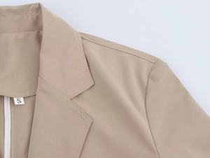 Detail shot of khaki blazer lapel and shoulder stitching with S size label