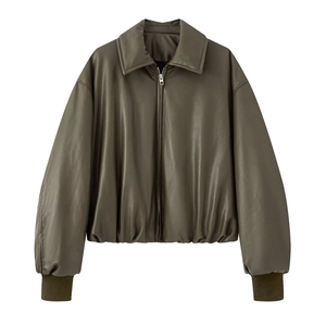 Close-up of olive green PU leather jacket showing ribbed elastic hem and metal zipper detail