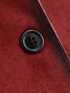 Close-up of wine red suede jacket featuring fine texture and a black four-hole button