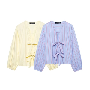 Detail of V-neck striped shirts with bow ties and lantern sleeves on white background