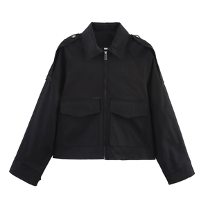 Detail view of black cropped jacket featuring large chest pockets and shoulder epaulettes
