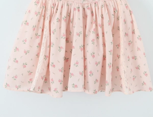 Detail of light pink floral summer dress with lace splicing and dainty rose print