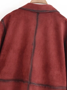 Detailed back view of a burgundy suede jacket featuring contrast black raw edges