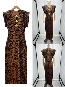 Detail of leopard print maxi dress with shoulder pads and shell-shaped metal buckles