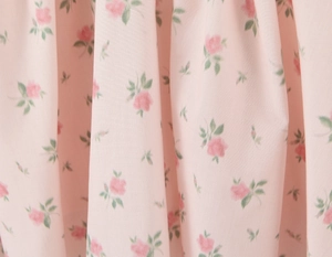 Detailed macro view of soft pink floral print fabric on summer V-neck sleeveless dress
