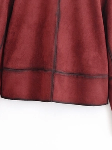 Detailed close-up of wine red faux suede jacket hem with dark contrast stitching details