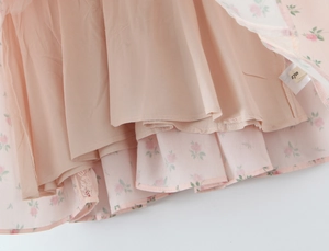 Detail view of pink rose floral chiffon skirt hem with high quality lining and size S tag