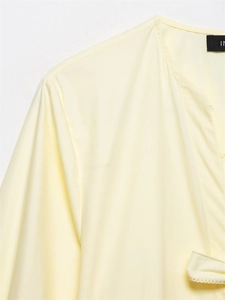 Detailed view of striped shirt fabric texture with decorative bow tie and V-neckline