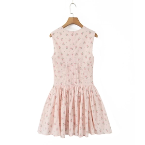 Close-up of pink floral dress featuring lace waist trim and detailed pleated skirt texture