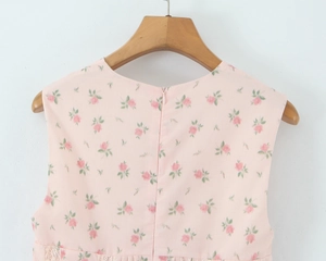 Detailed back view of pink floral dress featuring invisible zipper and white lace trim