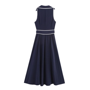 Close-up of navy blue sleeveless midi dress with white polka dots and belted waist