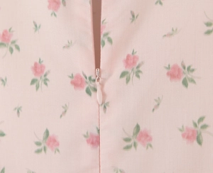 Close-up of pink floral dress featuring a matching invisible zipper for a seamless finish