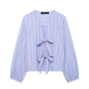 Detail of blue striped V-neck blouse featuring decorative bow ties and long sleeves