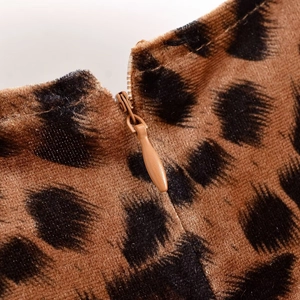 Macro shot of brown leopard print velvet dress showing the seamless invisible zipper detail