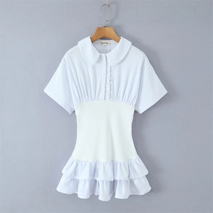Detail of white Peter Pan collar and ruffled placket on a slim short-sleeve dress