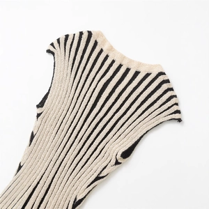 Sleeveless striped knit top with classic black and cream vertical ribbed texture