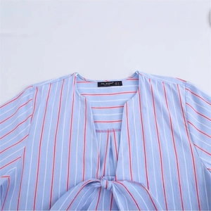 Women's blue and white striped blouse with vertical lines and a front bow tie detail