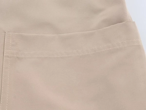 Detailed view of khaki woven blazer pocket with precise double-row stitching detail