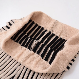 Vertical striped knit trousers featuring a high-waisted elastic band in beige and black