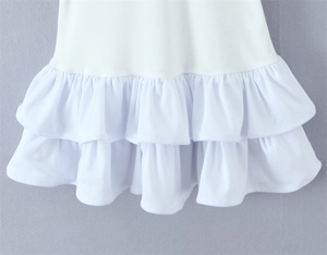 Detailed view of the layered white ruffles on the hem of a stylish slim fit dress