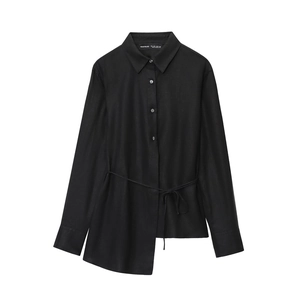 Detail of black long-sleeve shirt featuring an asymmetric hem and adjustable waist tie