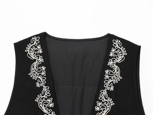 Detail of white floral embroidery on a black V-neck vest made of premium thick fabric