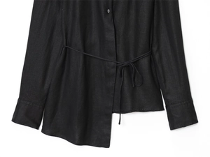 Detail of black linen-blend shirt featuring asymmetrical hem and waist tie closure