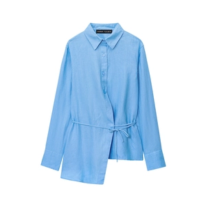 Detail view of the light blue linen shirt featuring a drawstring waist and asymmetric hem