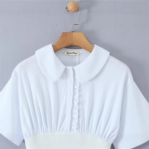 White short-sleeved women's blouse with Peter Pan collar and ruffled neck details