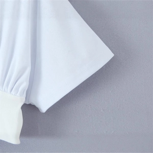 Close-up of white slim fit ruffled dress featuring premium ribbed texture and knit details