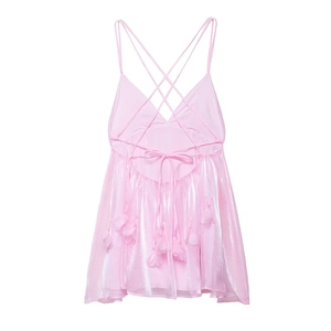 Detail of pink backless mini dress featuring criss-cross straps and 3D floral appliques