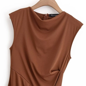 Detail of brown sleeveless knit dress featuring elegant waist pleats and cowl neckline