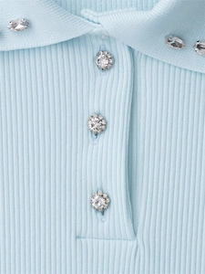 Detail of light blue ribbed knit top with sparkling rhinestone buttons and collar accents