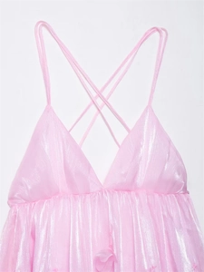 Close-up of pink V-neck dress with metallic texture and crisscross spaghetti straps