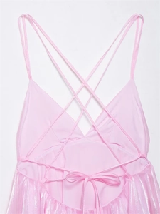 Detail view of pink satin dress with delicate criss-cross straps and back tie bow design