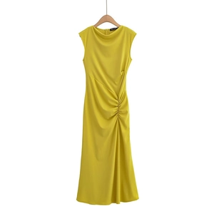 Detail of mustard yellow sleeveless knit dress showing side ruching and slim fit texture