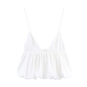 Detailed macro view of the ruched bubble hem and silk-like fabric of the white camisole