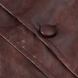 Makro-Detail von dunkelbraunem Leder mit präzisen Nähten und einem bezogenen Knopf