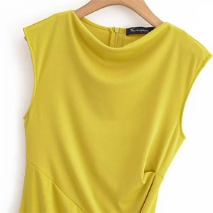 Close-up of a yellow sleeveless dress with draped cowl neck and back zipper detail
