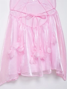 Detail of pink pearlescent fabric with back cross straps and 3D floral decorations